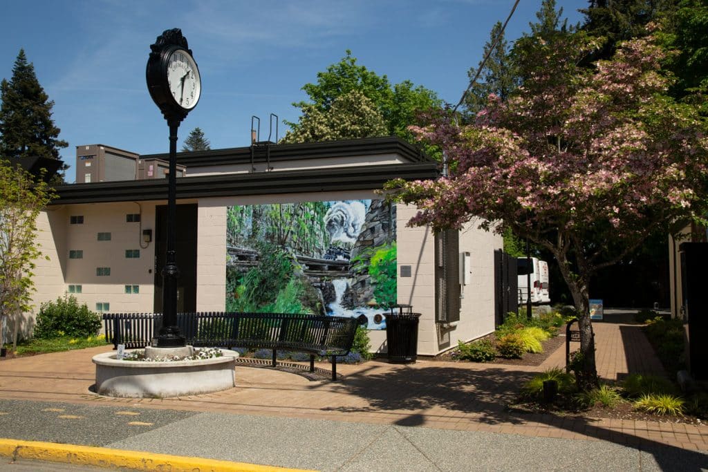 Clock, mural, trees, peaceful setting