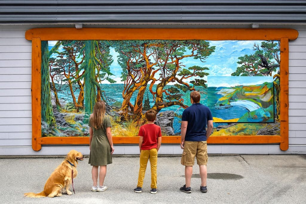 Family admiring a colorful mural.