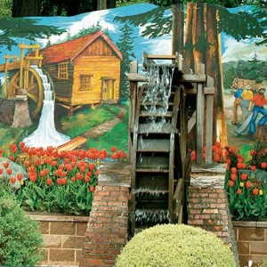 Watermill mural with flowers and trees.