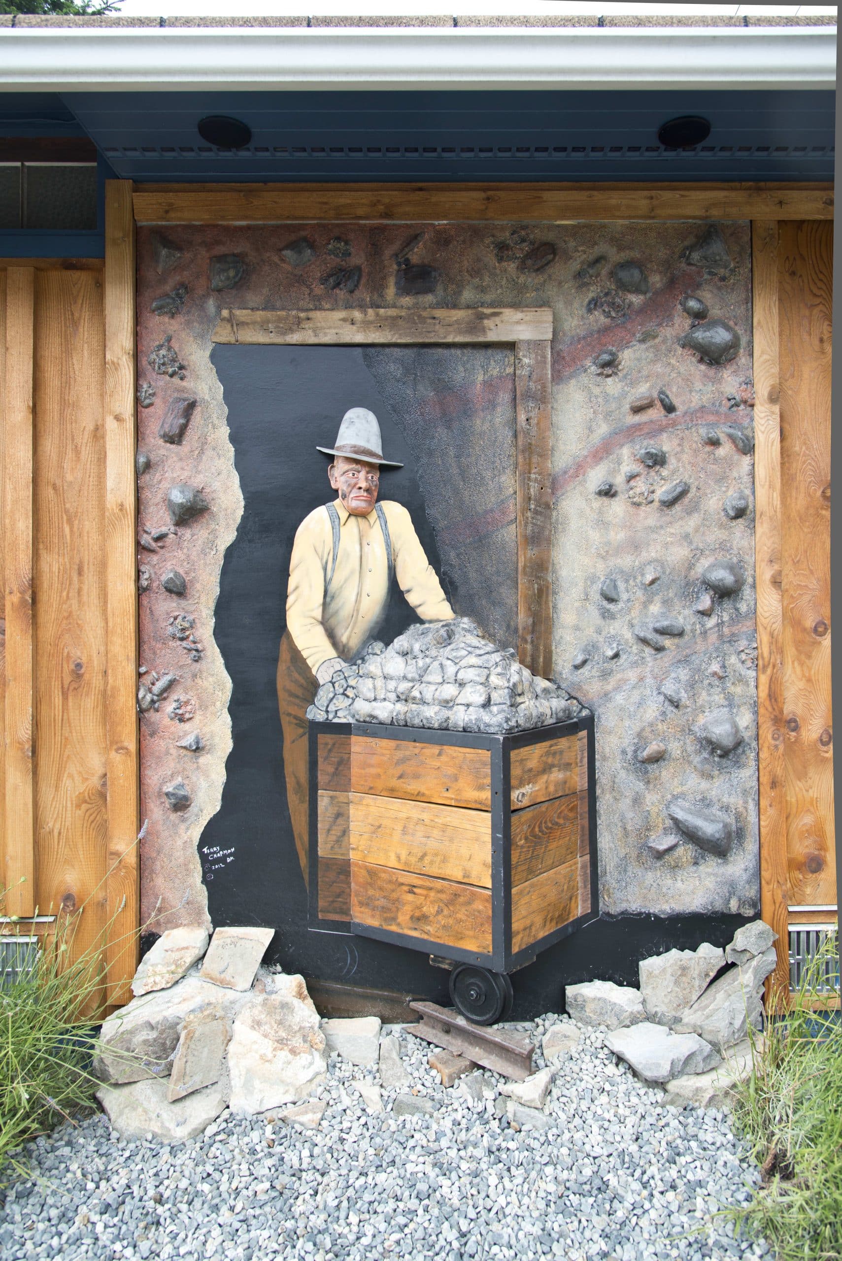 Mural of miner with cart.