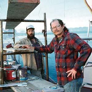 Two men working on a boat.