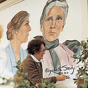 Artist painting a mural on wall.