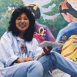 Artist holding palette, colorful background.